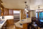 Gourmet kitchen with range, bar seating and stainless steel appliances  